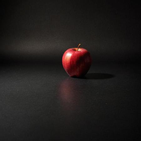 an image of a red apple in front of a black bacground under studio lighting, in hdr format